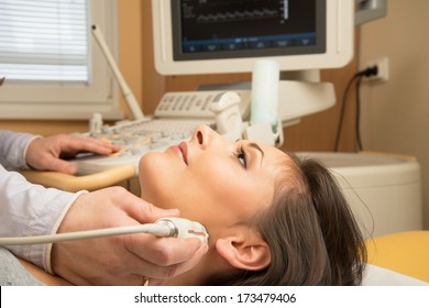 Young Woman Doing Neck Ultrasound Examination At Hospital