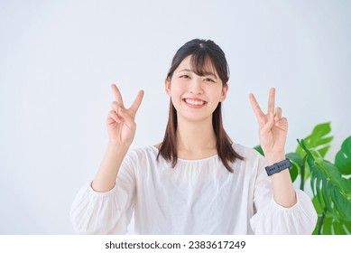 young woman doing peace sign                           