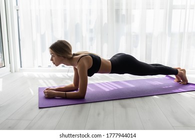 Young Woman Doing Plank Exercise At Home Concept Training Workout Crossfit Gymnastics Cross Fit.