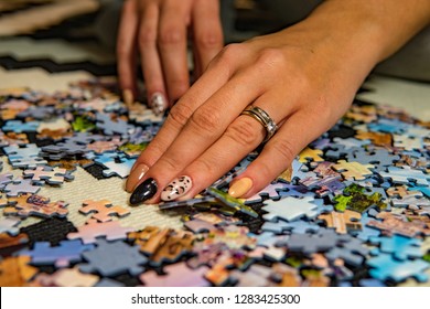 Young Woman Doing Puzzle At Home