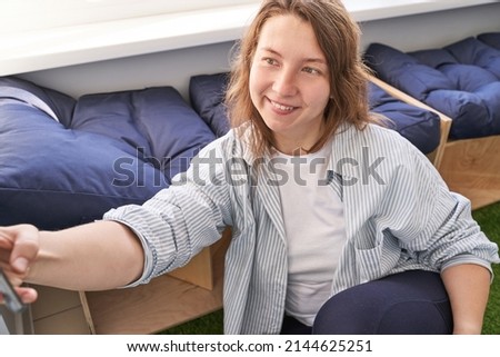 Young woman doing self portrait indoors. Home vacation portrait. Blogger selfie video. Alone in interior. Happy emotion. Smiling female person. Lifestyle action. Posing
