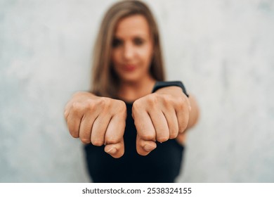 Young woman doing shadow boxing training outdoor - Powered by Shutterstock