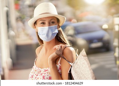 Young Woman Doing Shopping In Tourist Area, Wearing Face Mask