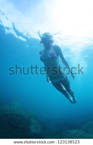 Young woman doing skin diving in a tropical sea