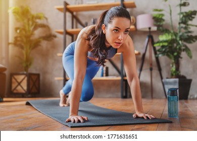 Young Woman Doing Sport Exercises Indoor At Home