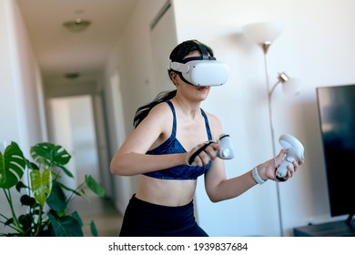 Young Woman Doing VR Kickboxing At Home