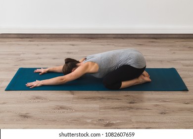 Young Woman Doing Yoga In Child's Pose