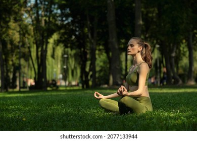 Young Woman Doing Yoga Exercise Outdoor In The Park, Sport Yoga Concept