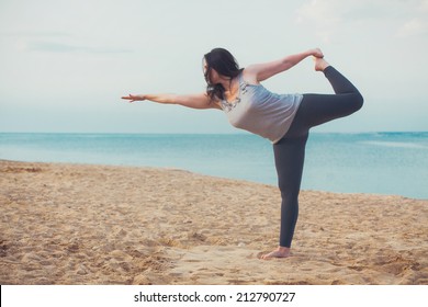 Young woman doing yoga exercise outdoors