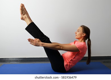 Young woman doing yoga exercise static for press and core