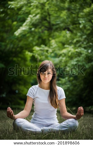 Similar – Young woman doing yoga in nature