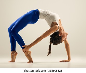 Young woman doing Yoga exercises. studio. Bridge pose - Urdhva Dhanurasana
