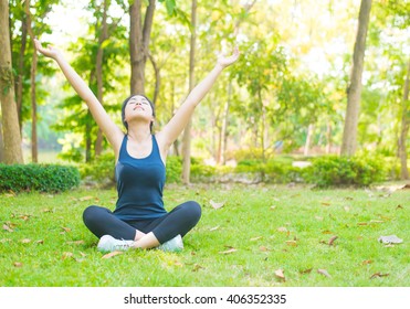 Young Woman Doing Yoga In Morning Park