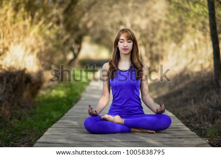 Similar – Young woman doing yoga in nature