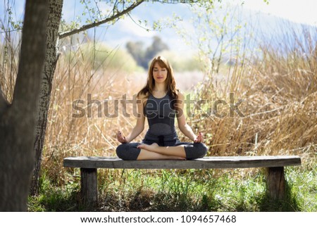 Young woman doing yoga in nature