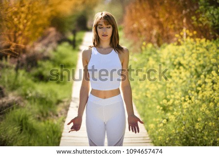 Similar – Young woman doing yoga in nature