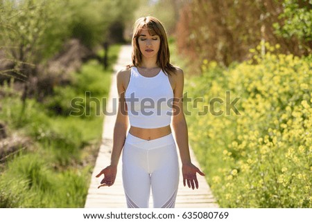 Young woman doing yoga in nature