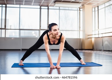 Young woman doing yoga in studio - Shutterstock ID 464781596