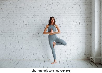 Young Woman Doing Yoga, Tree Pose