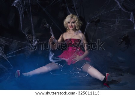 young woman in dolls dress in a dark interior. Low key