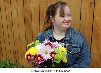 Young Woman With Down Syndrome In Garden