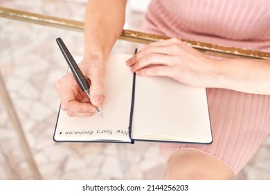 Young woman drawing goals indoors  Psychology treatment  Home vacation flatlay  Alone in interior  Happy emotion  Female person hands  Lifestyle action  Posing table