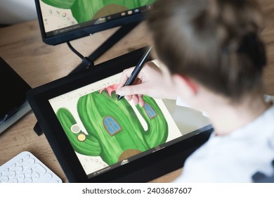 Young woman drawing on a digital tablet. Female graphic designer working from home. Girl drawing on a digital drawing board, view from behind - Powered by Shutterstock