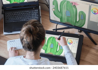 Young woman drawing on a digital tablet. Female graphic designer working from home. Girl drawing on a digital drawing board, view from behind - Powered by Shutterstock