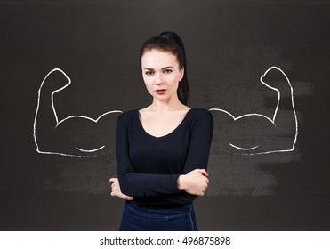 Young woman with drawn powerful hands - Shutterstock ID 496875898