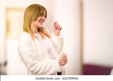 Young Woman In Dressing Gown Dancing Inside A Room