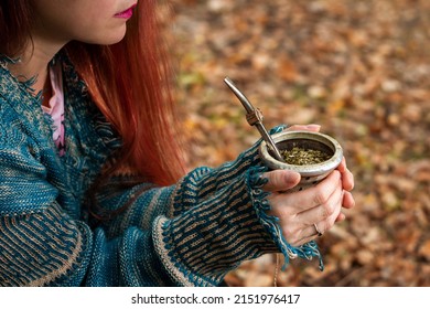 Young woman drinking Argentinian mate on an autumn day. Young woman enjoying an afternoon with Argentinian mate. Argentine mate. Argentinian culture. Argentinian traditions