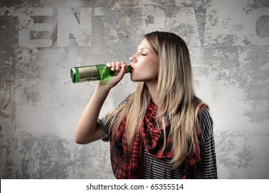 Young Woman Drinking A Beer