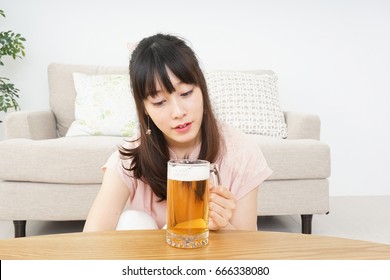 Young woman drinking beer