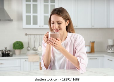 Young Woman Drinking Chocolate Milk In Kitchen