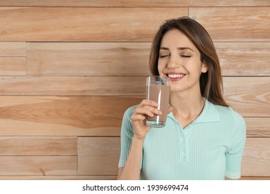 Young Woman Drinking Chocolate Milk On Wooden Background. Space For Text