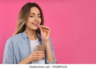 Young Woman Drinking Chocolate Milk On Pink Background. Space For Text