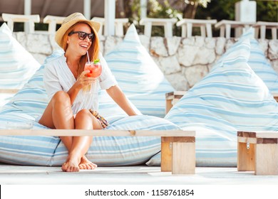 Young Woman Drinking Cocktail In A Beach Bar