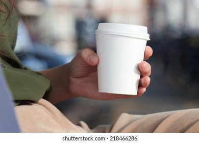 Young Woman Drinking Coffee From Am Disposable Cup