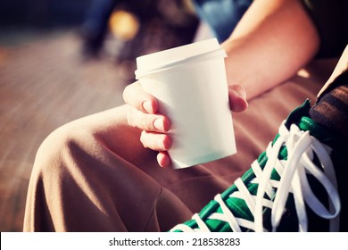 Young Woman Drinking Coffee From Am Disposable Cup