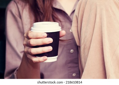 Young Woman Drinking Coffee From Am Disposable Cup