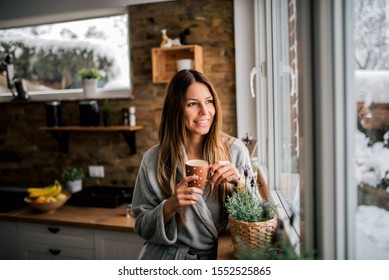 Young woman drinking coffee in the morning, looking at window. - Powered by Shutterstock