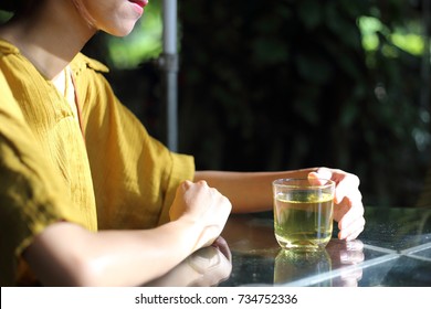 Young Woman Drinking Green Tea In Cafe In Vietnam