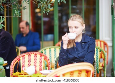 Young Woman Drinking Hot Chocolate In Parisian Outdoor Cafe