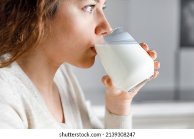 Young woman is drinking milk 