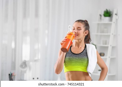 Young Woman Drinking Protein Shake Indoors