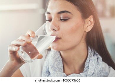 Young Woman Drinking Pure Glass Of Water