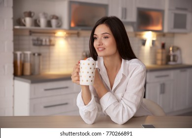 Young Woman Drinking Tea In Kitchen