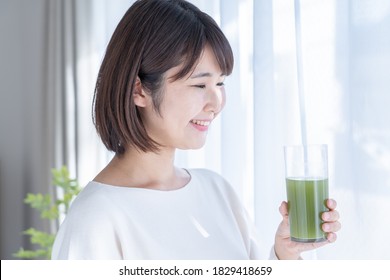 Young Woman Drinking Vegetable Juice
