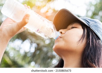 A Young Woman Drinking Water Thirsty From Hot Weather.