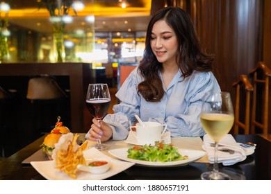 young woman drinking wine in the restaurant